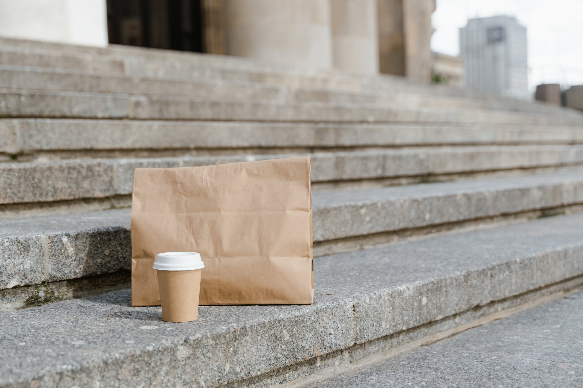 brown paper bag on concrete stairs
